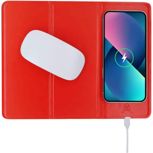 A red mousepad with a wireless charger and a smartphone displaying a charging indicator.