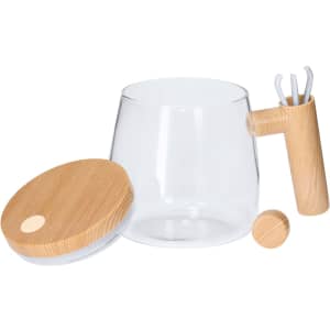 A clear glass mixing mug with a wooden lid and handle, accompanied by three mixing tools in a wooden holder.