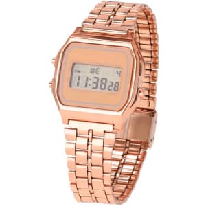 A rose gold digital watch with a rectangular face and a linked metal strap, featuring a branding logo.
