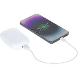 A white power bank connected to a smartphone, both resting on a flat surface. The power bank has a branding logo.