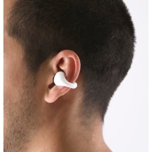 A pair of white earphones is displayed in a person's ear, showcasing the sleek design and fit.
