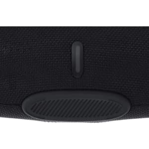 A black speaker with a textured surface and a ridged control panel. Features a logo on the front.
