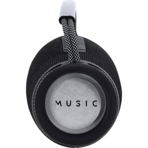 A black cylindrical speaker with a textured surface and a looped handle, featuring a silver base with the word "MUSIC".