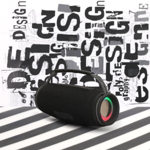 A portable black speaker with a handle and colourful accents, set against a graphic background.