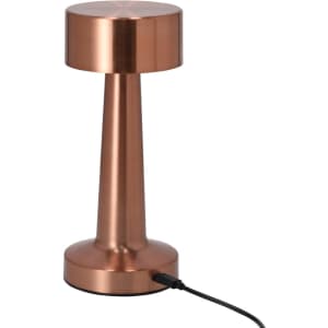 A copper lamp with a cylindrical base and a round top, featuring a power cord at the base.