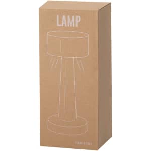 A tall, cylindrical lamp in a cardboard box, featuring a simple design with a round base and a light shade on top.