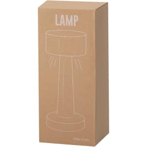 A brown cardboard box containing a lamp, featuring a simple line drawing of the product. It has a logo.