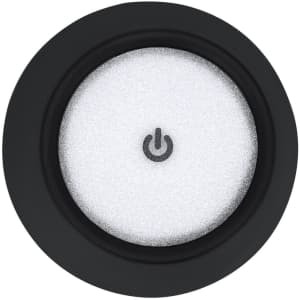 A round, black lamp base featuring a white light activation button in the centre.