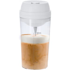 A drink bottle with a white lid, clear body, and measuring markings filled with layered iced coffee.