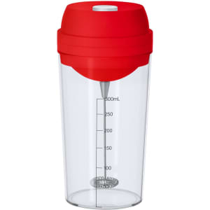 A drink bottle with a transparent body and a red lid, featuring a measuring scale and a whisk inside.