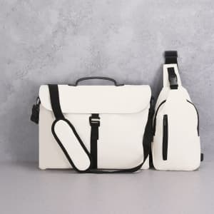 A white shoulder bag with black accents, featuring adjustable straps and a branding logo.