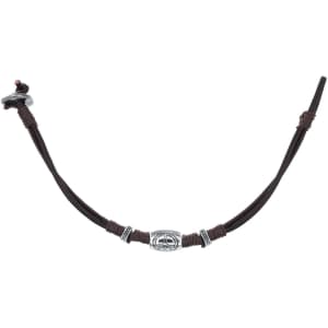 A brown leather bracelet featuring silver beads and a central decorative element, along with a clasp.