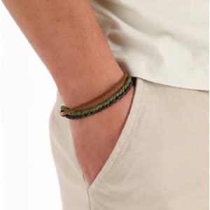 A wrist adorned with a multi-strand bracelet in earthy tones of green and brown.