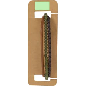 A bracelet featuring braided leather and green beads, displayed on a cardboard backing.