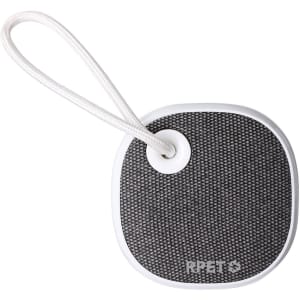 A compact black and white speaker with a textured surface and a looped strap for easy carrying.