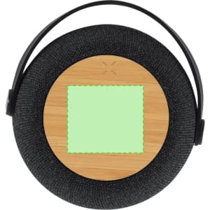 A round speaker with a black fabric exterior and a wooden centre, featuring a green square area and a handle.