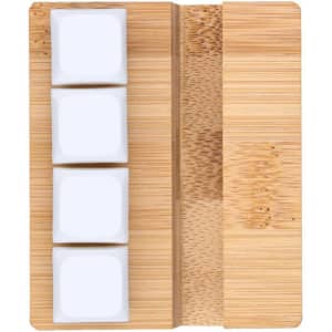 A bamboo phone stand featuring three white ceramic tiles for support. It includes a natural wood finish.