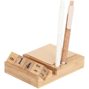 A bamboo desk calendar with a notepad, two pens, and a minimalist design in natural tones.
