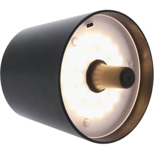 A black and gold lamp with a round design and a warm light source. It features a subtle logo on the side.