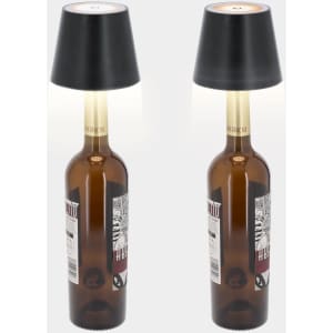 A decorative lamp featuring a black shade and a brown glass bottle base. The design incorporates a logo.
