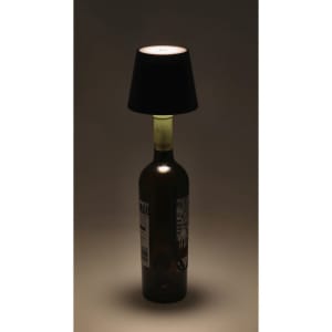 A stylish lamp featuring a black shade atop a green glass bottle, creating a unique decorative piece.