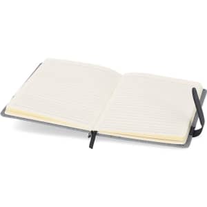 An open notepad with lined pages and a grey cover, featuring a black ribbon marker and branding.