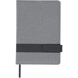 A grey notepad with a textured cover and a black elastic band closure. It includes a pen attached to the side.