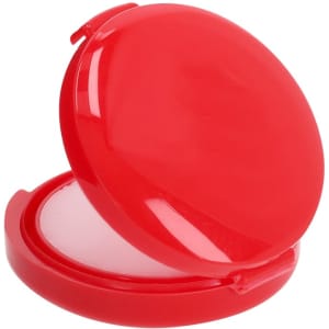 A round red container of Blexik Lip Balm, with the lid open, revealing the smooth balm inside.