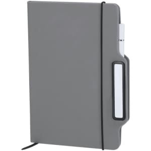A grey notepad with a flexible cover, elastic band, and a holder for a pen. It has a simple design and branding on the cover.