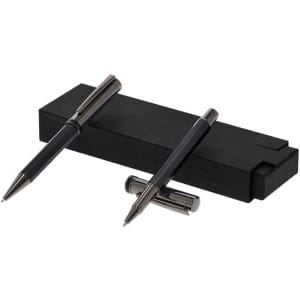 A set of two sleek black metal pens resting on a matching black box, with a simple logo present on the box.