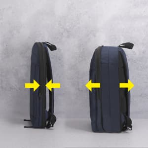 A navy blue backpack with a side view, showcasing its expandable design and branding.