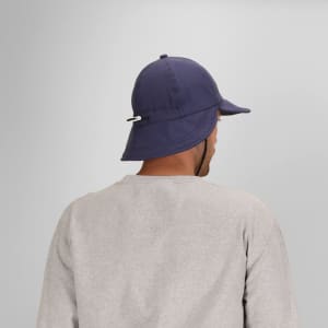 A navy cap with a wide brim and an adjustable strap at the back, featured on a model from a rear angle.
