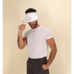 A white sun visor featuring a fan design, worn by a model in a plain white t-shirt and grey trousers.