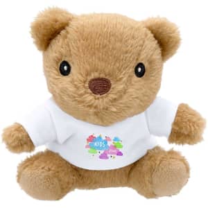 A tan plush teddy bear wearing a white shirt with a logo, featuring round ears and dark eyes.