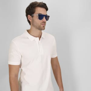Chick sunglasses with a sleek design and blue lenses, worn by a man in a white polo shirt.