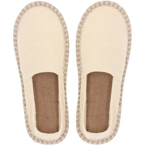 A pair of cream espadrilles with jute soles, featuring a simple, slip-on design.