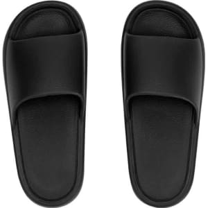 A pair of black flip flops with a smooth surface and wide straps. The footwear features a simple design.