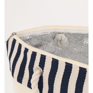 A striped cooler bag featuring navy and cream colours, with a silver insulated interior and rope handles.