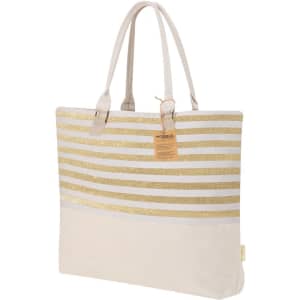 A tote bag featuring gold glitter stripes on a cream background, with two sturdy handles and a tag attached.