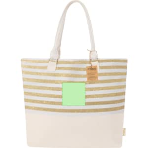 A tote bag featuring gold and white striped patterns with a solid cream base and a green square area. It has a logo.