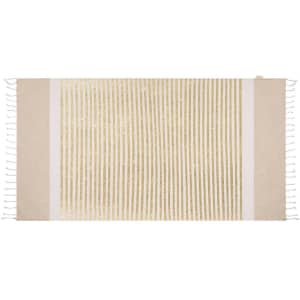 A bath towel in beige and gold with striped pattern and tasselled edges, featuring a logo.