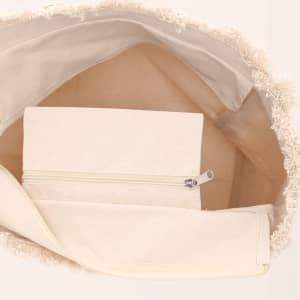 An open cream tote bag revealing a smaller cream zippered pouch inside. The bag features textured detailing along the edge.