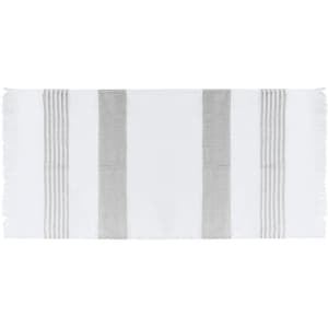 A white and grey striped towel resembling a pareo, featuring fringe edges and a branding logo.