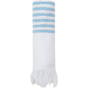 A rolled white towel with blue striped patterns and fringed edges, featuring a logo.