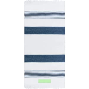 A striped towel in white and navy blue, featuring a fringed edge and a logo. Suitable for beach or outdoor use.