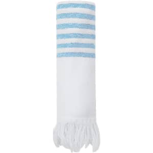 A rolled towel with white and light blue stripes, featuring fringed edges. It has a branding logo on the towel.