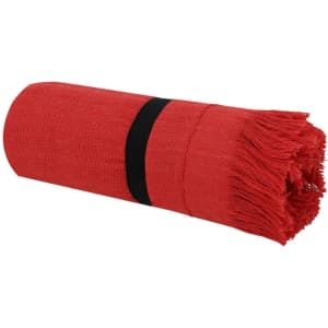 A rolled red towel with fringed edges secured by a black band, featuring a simple design.