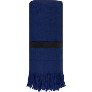 A blue towel with fringed edges, neatly rolled and secured with a black band.