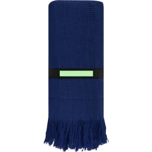 A dark blue towel with fringed edges, neatly rolled and secured with a black band featuring a logo.