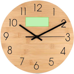 A round bamboo wall clock featuring large black numbers and clock hands, with a blank green area for notes.
